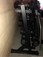 Front angle of black two-tier steel dumbbell rack loaded with hex dumbbells.