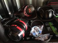Overview of all four audio products including three over-ear headsets and one in-ear earphone set with case