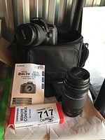 Overview of camera body, both lenses, bag, charger, manual, and remote control box