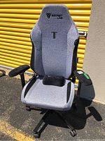 Full view of gray SoftWeave Secretlab Titan chair showing headrest, seat, armrests, base and caster wheels