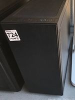 Front and side view of black tower case showing solid front panel and part of adjacent towers.