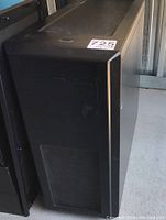 Front view of black tower showing drive bays and mesh vent