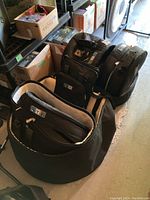 Overall view showing four black drum cases and a rectangular stick bag on floor