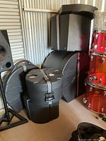Stack of five drum cases and one cymbal case in storage unit