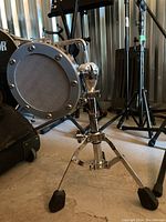 Front quarter view showing mesh grille and tripod base