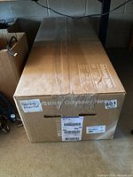 Sealed Samsung Odyssey Neo G9 box showing shipping label and brand signage