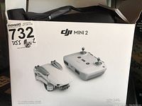 Front of DJI Mini 2 Fly More Combo box showing drone and controller graphic