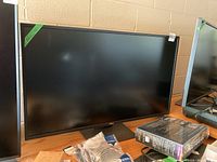 Front view of monitor and stand on wooden surface