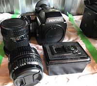 Pentax 645N body with two lenses and film box