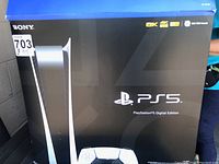 Box front showing Sony PS5 Digital Edition branding and spec logos