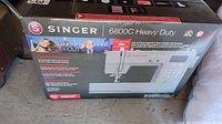 Front of original box showing Singer logo, model 6800C Heavy Duty name and Amazon Original Making the Cut graphic