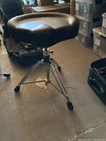 Full view of black DW drum throne stool showing padded seat and tripod base