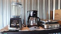 Front view of all three appliances: blender, coffee maker, waffle maker