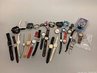 Full lot spread out showing all 20 watches in a single arrangement with various band materials and colors.