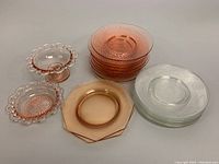 Overall view of the glassware set showing luncheon plates, hexagonal plates, and pedestal bowls.