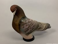 Front right side view of the pigeon sculpture showing overall form and raku glaze coloration
