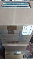 Sealed cardboard box containing approx. 100 vinyl records, showing the top open side with vinyl sleeves packed tightly.