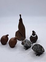 Group of small vintage ceramic and metal bird figurines; includes various brown ceramic birds and metal birds with texture details.