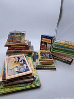 Photo of assorted vintage and kids books stacked and arranged in piles