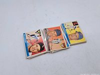 Front side of three vintage baseball cards showing player images and team logos in color.