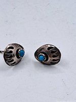 Front view of both earrings showing bear claw design and turquoise stones