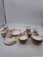 Full set showing all cups, saucers, side plates, and bowls arranged.
