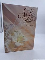 Photo of original Star Lily Bride Barbie box showing the product name and floral design.