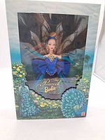 Front full view of the boxed Peacock Barbie showing doll and packaging design with peacock feathers and floral accents.