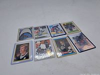Eight Wayne Gretzky hockey cards arranged in two rows on a white surface, showing front of cards.