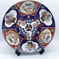 Front view of the vintage Japanese Imari round platter showing colorful floral and bird patterns with red, blue, and gold accents.