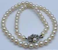 Full view of the Akoya pearl necklace with visible box clasp, showcasing the pearl strand and clasp design.