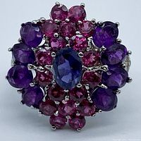 Top view close-up of ring showing detailed cluster of amethyst and garnet stones in silver setting