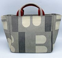 Front view of Bally textile tote bag with large B logo pattern and red and white striped handles.