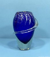 Front view of cobalt blue art glass vase showing clear glass swirl accent and overall form.