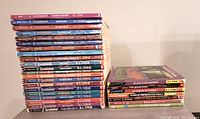 Stack of 28 Goosebumps books in varying colored paperback editions depicting the lot
