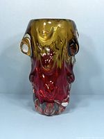 Front view of the amber to red gradient art glass vase with clear glass sculptural details.