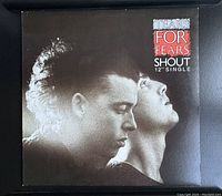 Front cover of the vinyl single showing a black and white photo of two men in profile with band and single title text.