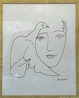 Close-up of the lithograph showing the bird and woman's face with Picasso signature.
