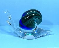 Side view of the Murano glass snail figurine highlighting the clear glass body and blue-green spiral shell.