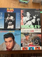 Four Elvis Presley LP vinyl records displayed: Moody Blue, Elvis Presley, Loving You, and A Date with Elvis with front covers visible.