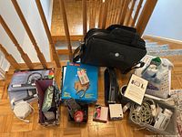 Overview of all items including computer bag, cleaning sprays, file folders, cords, stapler, and other items.