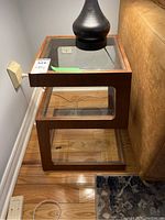 Single table in corner with lamp, showing full profile and cut-out frame.