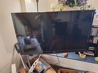 Front view of turned off 50 inch flat screen TV with attached wall mount bracket.