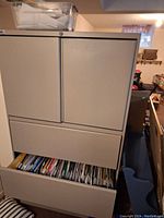 Exterior view of closed filing cabinet with two drawers partially opened showing hanging folders.