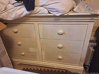Photo of white 8 piece dresser showing front view with 8 drawers, 4 on each side, two single units combined side-by-side.