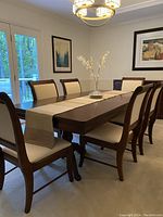 Six dining chairs around a wooden table in dining room