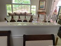 First photo of 8 glasses with four styles, showing them in front of a couch and window.