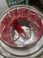 Close up of the clear lid of the Cuisinart ice cream maker showing star-shaped opening.