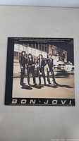 Back cover photo showing Bon Jovi band members standing outside building, with track listing on top