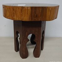 Front side view of custom made wooden table with thick top and decorative legs